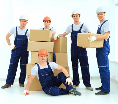 Local moving truck service handling boxes and household items in Watford