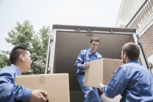 Furniture and office items being loaded into a moving truck in Watford