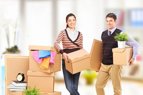 Professional movers preparing furniture for transport in Watford